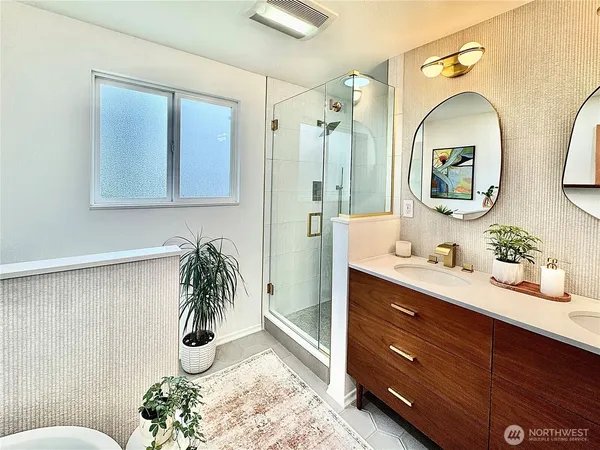 a white toilet sitting next to a bathroom sink and vanity