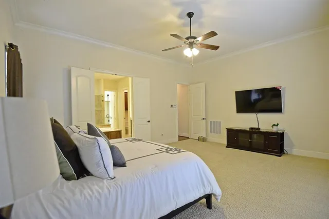 a bedroom with a bed and a flat screen television
