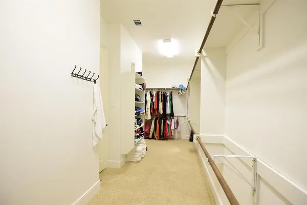 a view of walk in closet with clothes