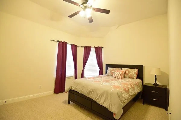 a bedroom with a bed and window