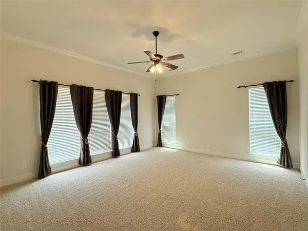 a view of a livingroom with a ceiling fan and window