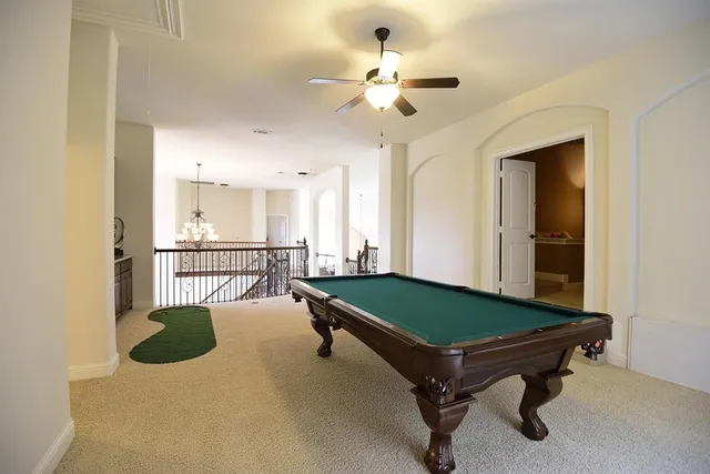 a bedroom with furniture and a chandelier