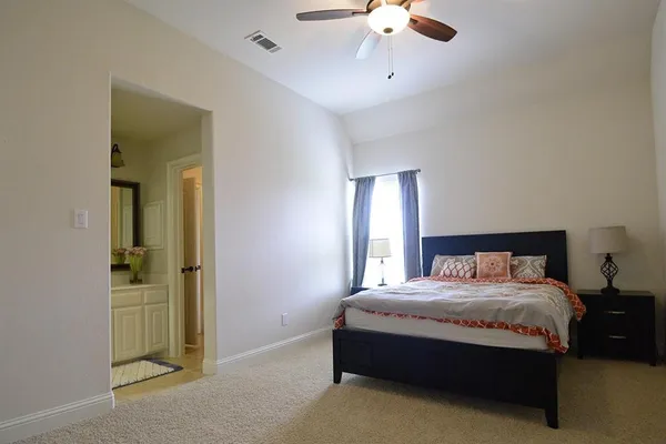 a bedroom with bed and window