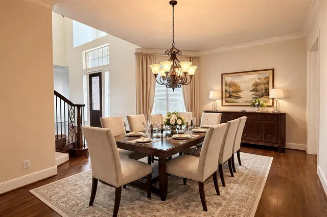 a view of a dining room with furniture wooden floor and a chandelier