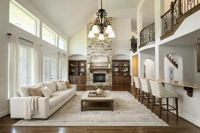 a living room with fireplace furniture and a chandelier