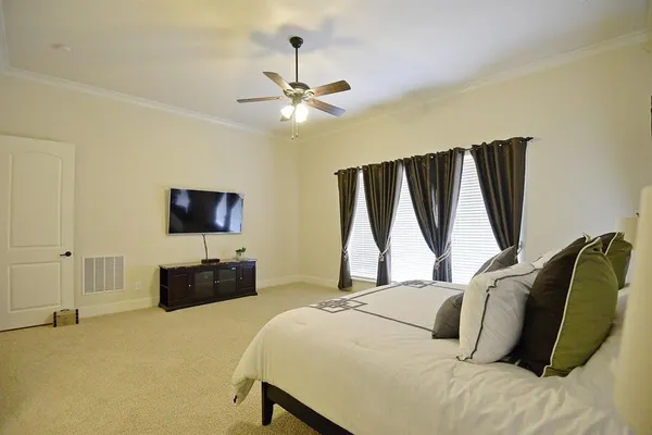 a bedroom with a bed and a flat screen tv