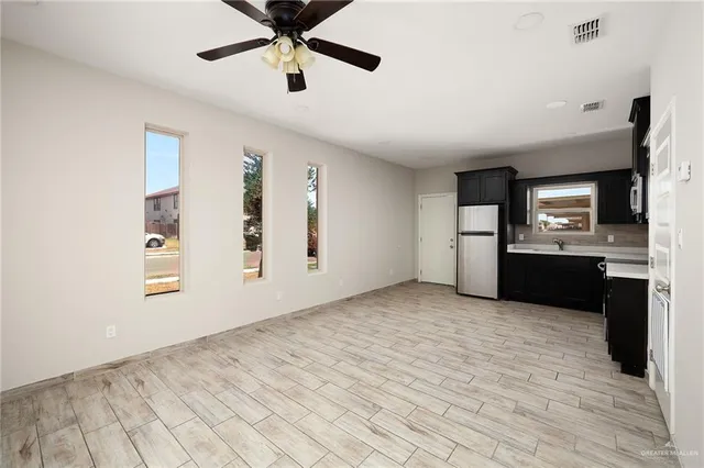 a view of a kitchen with a sink and cabinets