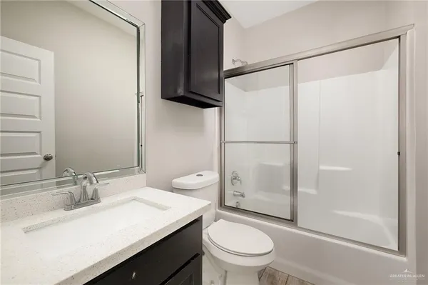 a bathroom with a sink toilet and shower