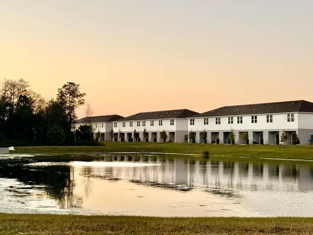 a view of a lake with a house in the background