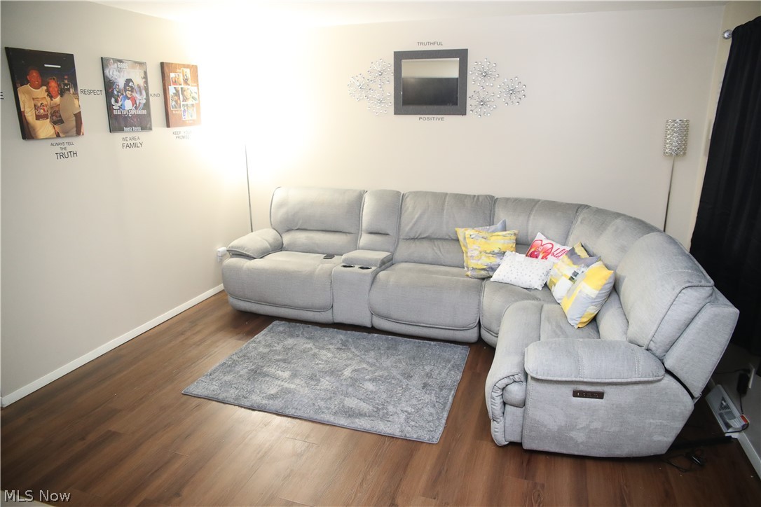 1258 Vane Avenue Akron, OH 44310 - Photo 3 of 12 Wood-finish flooring throughout, complemented by light-toned wall paint and white baseboards