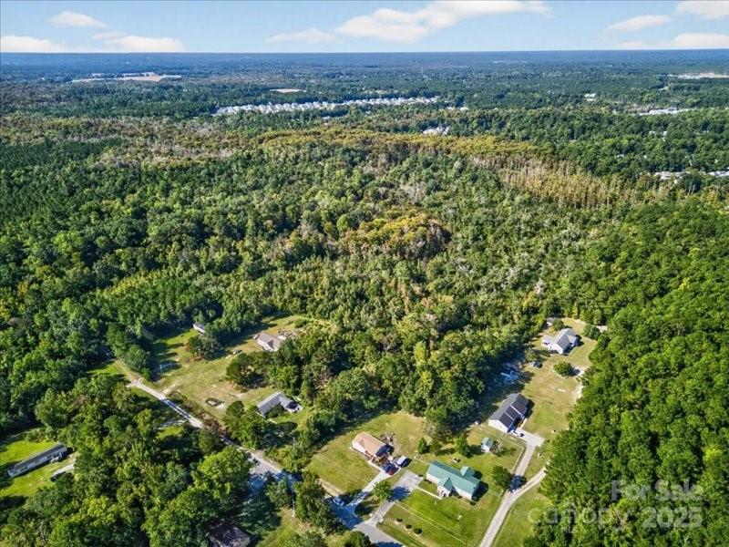 110 Unknown Name Road Southeast Leland, NC 28451 - Photo 12 of 27 a view of a lush green forest with a houses