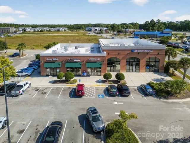 a view of multiple houses with outdoor seating