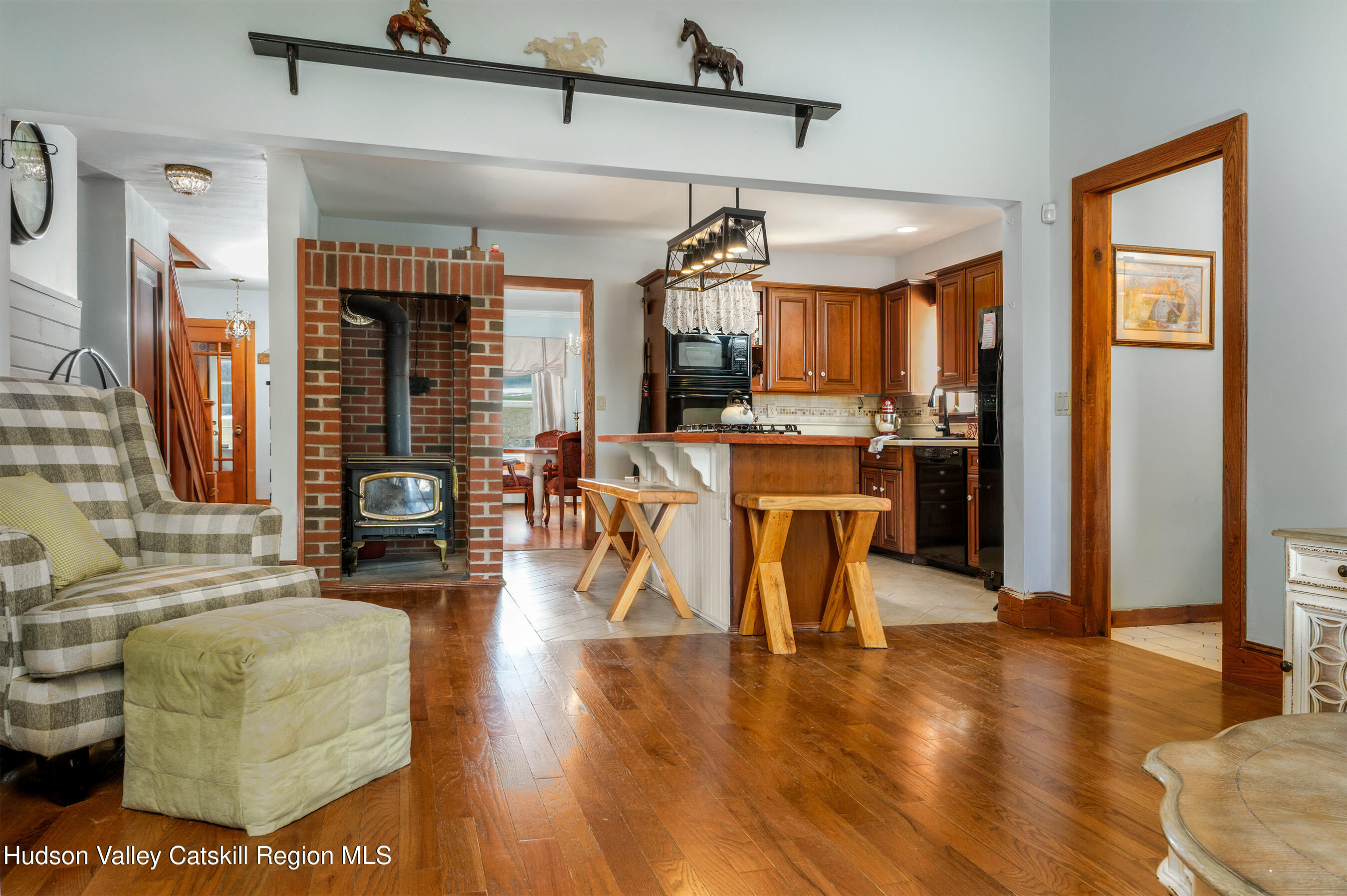 802 County Highway 3A Unadilla, NY 13849 - Photo 23 of 65 a dining room with wooden floor a glass table and chairs