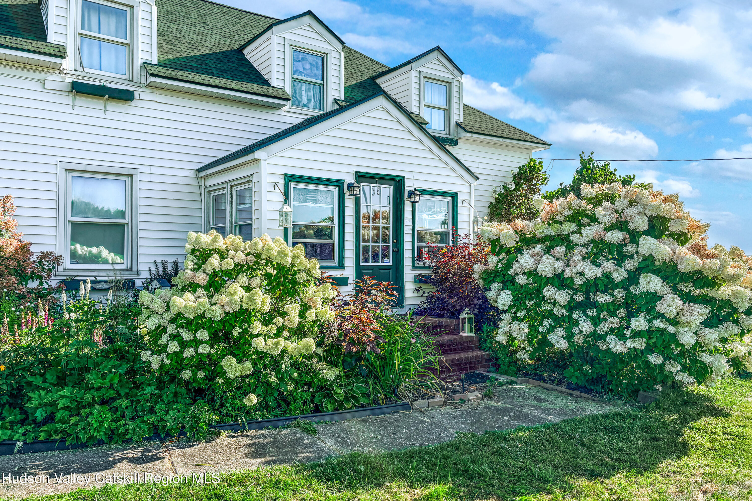 802 County Highway 3A Unadilla, NY 13849 - Photo 5 of 65 a front view of a house with a garden