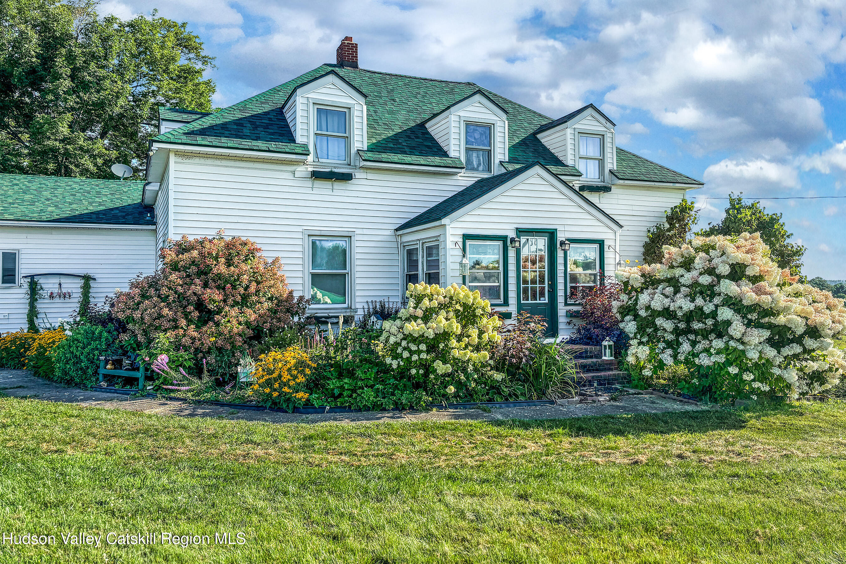 802 County Highway 3A Unadilla, NY 13849 - Photo 6 of 65 a front view of a house with a garden