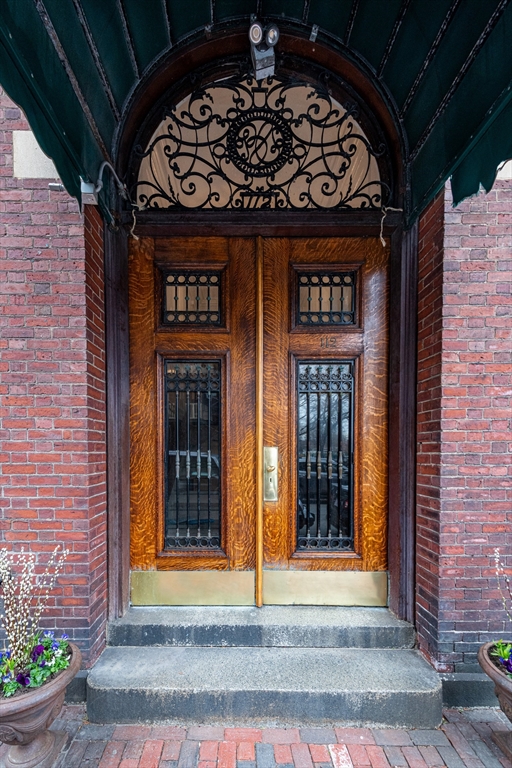 a view of a entryway door front of a brick building