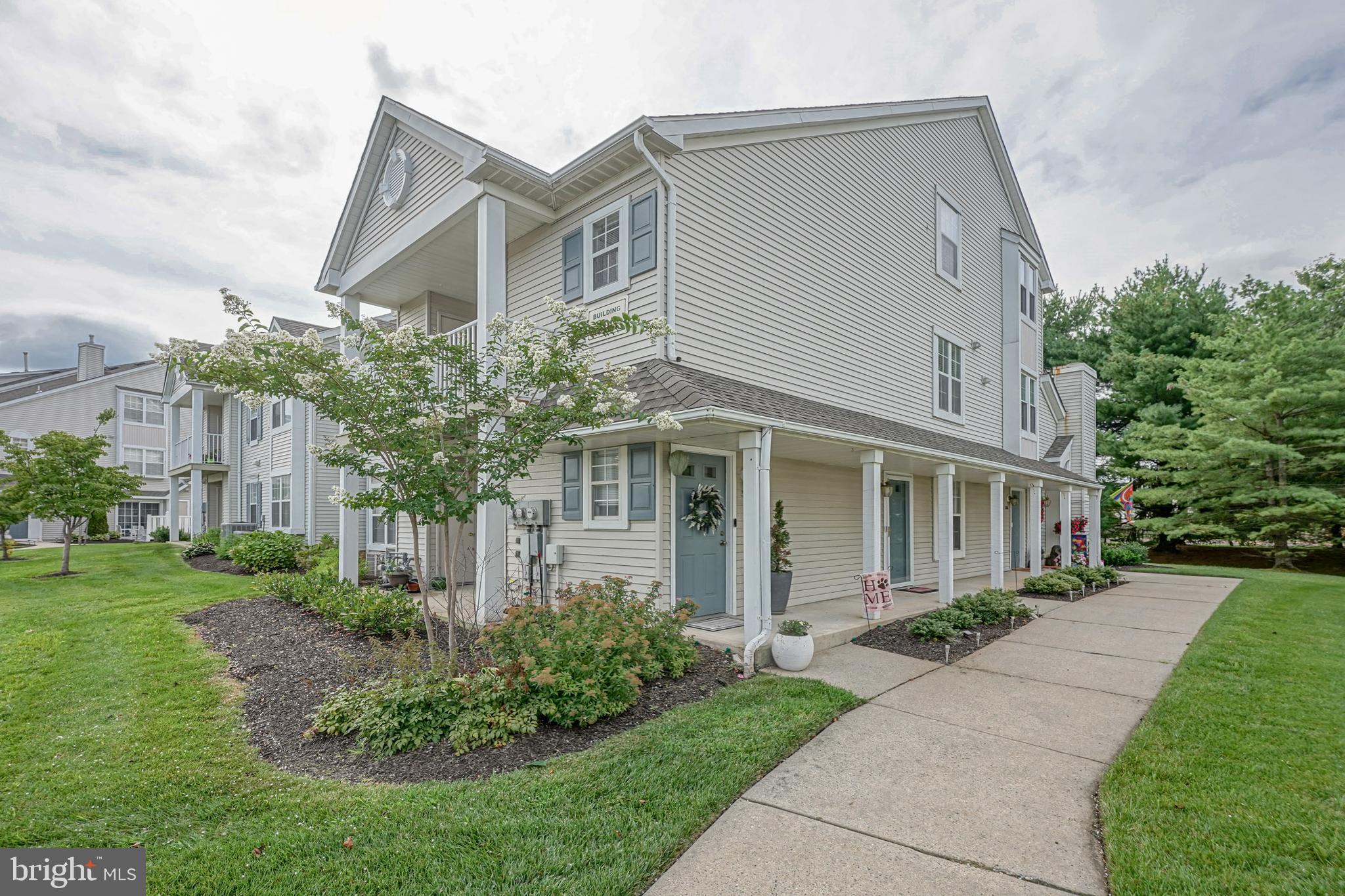 307 Wharton Road Mount Laurel, NJ 08054 - Photo 2 of 14 a front view of a house with a yard and potted plants