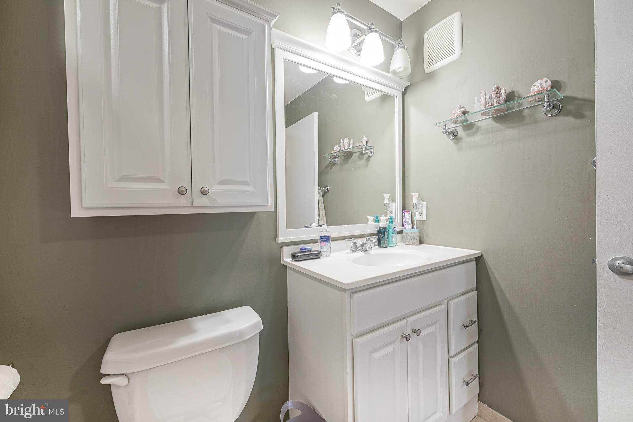307 Wharton Road Mount Laurel, NJ 08054 - Photo 11 of 14 a bathroom with a toilet sink vanity and mirror