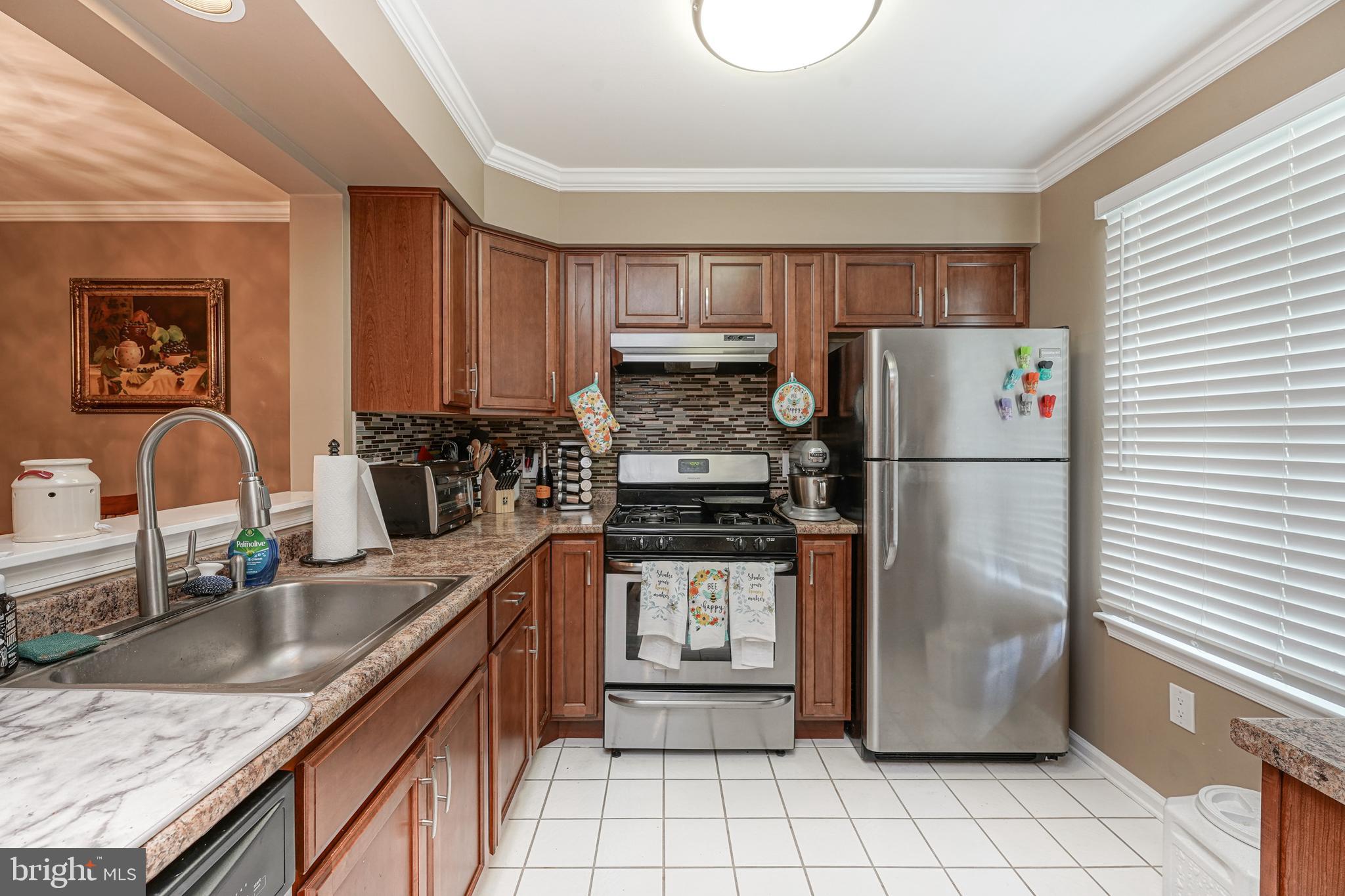 307 Wharton Road Mount Laurel, NJ 08054 - Photo 8 of 14 a kitchen with stainless steel appliances granite countertop a refrigerator a stove a sink and a granite counter tops with a large window
