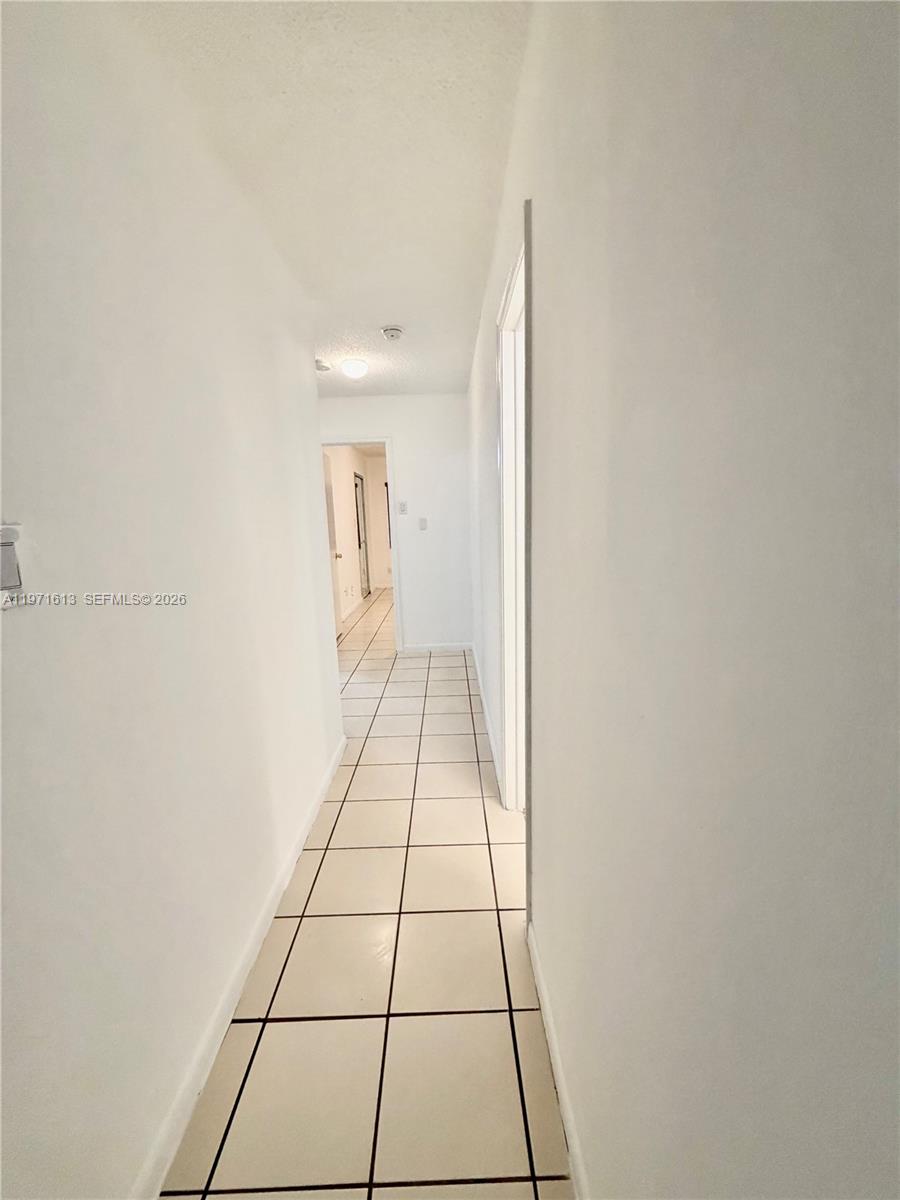 11535 Southwest 109th Road, Unit 22A Miami, FL 33176 - Photo 13 of 41 Hallway to bathroom and three bedrooms