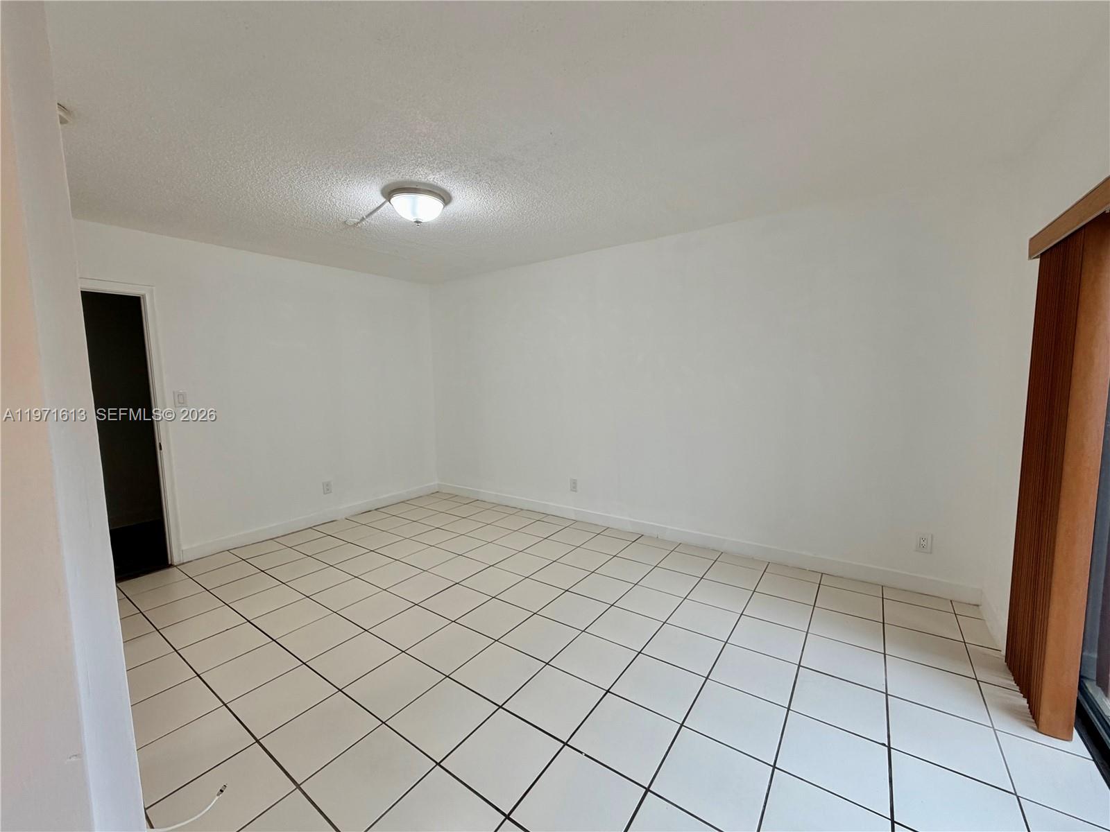 11535 Southwest 109th Road, Unit 22A Miami, FL 33176 - Photo 24 of 41 Large Family Room/Den with access to patio and laundry/utility/storage room