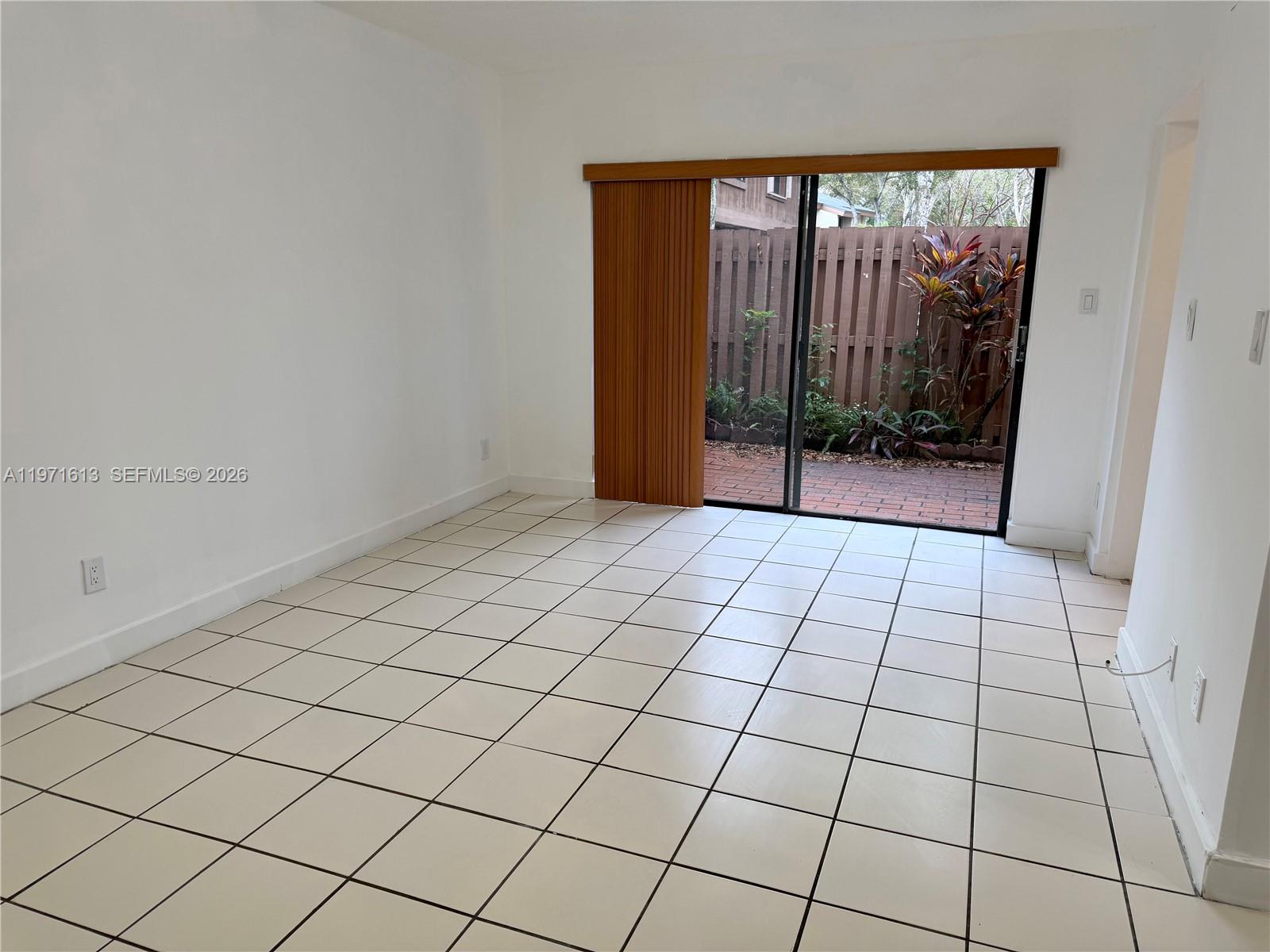 11535 Southwest 109th Road, Unit 22A Miami, FL 33176 - Photo 25 of 41 Family Room with access to fenced patio