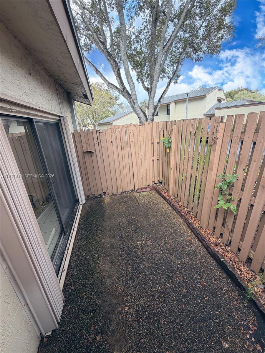 11535 Southwest 109th Road, Unit 22A Miami, FL 33176 - Photo 26 of 41 Fenced in patio accessible from family room - storm shutters included