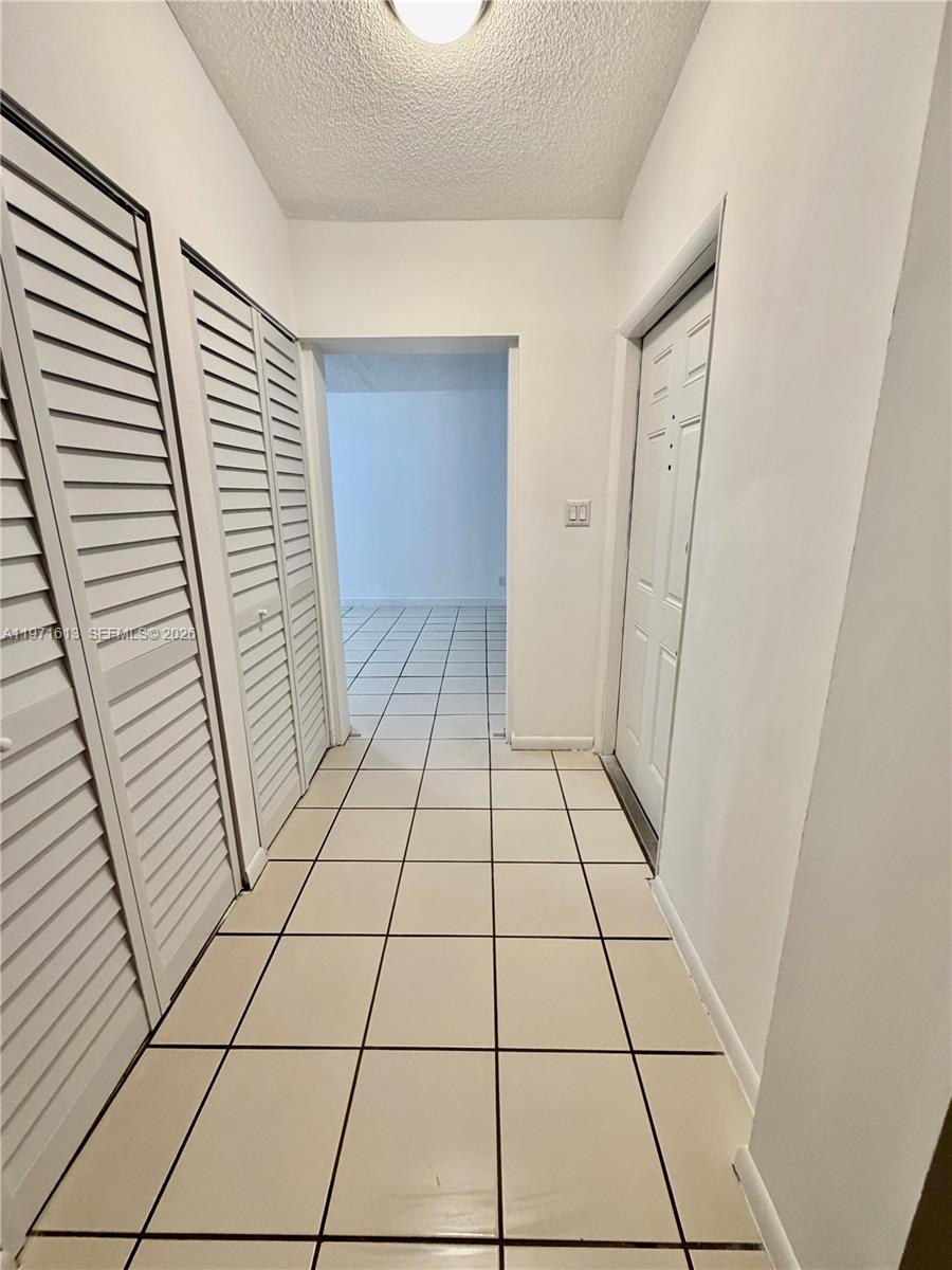 11535 Southwest 109th Road, Unit 22A Miami, FL 33176 - Photo 4 of 41 Foyer entrance with storage space and access to family room and living/dining areas