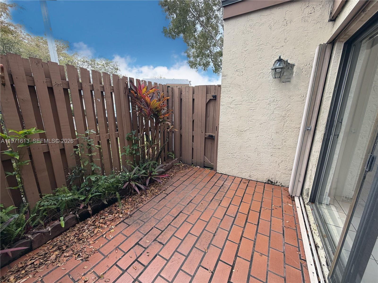 11535 Southwest 109th Road, Unit 22A Miami, FL 33176 - Photo 9 of 41 Tiled patio accessible from living/dining area - storm shutters included