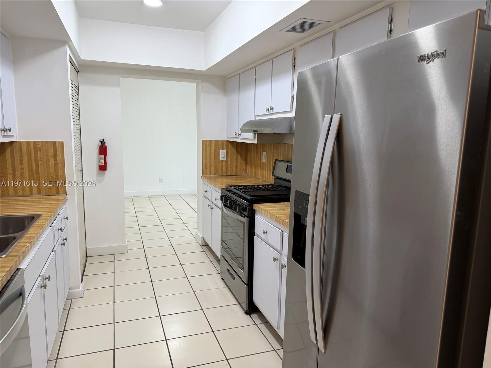 11535 Southwest 109th Road, Unit 22A Miami, FL 33176 - Photo 10 of 41 Galley kitchen with Stainless Steel Whirlpool Appliances (including gas range/oven)