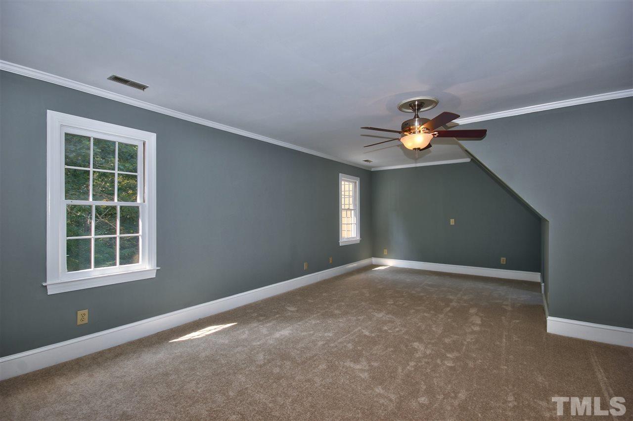 304 Key Court Raleigh, NC 27614 - Photo 12 of 25 an empty room with windows and chandelier fan