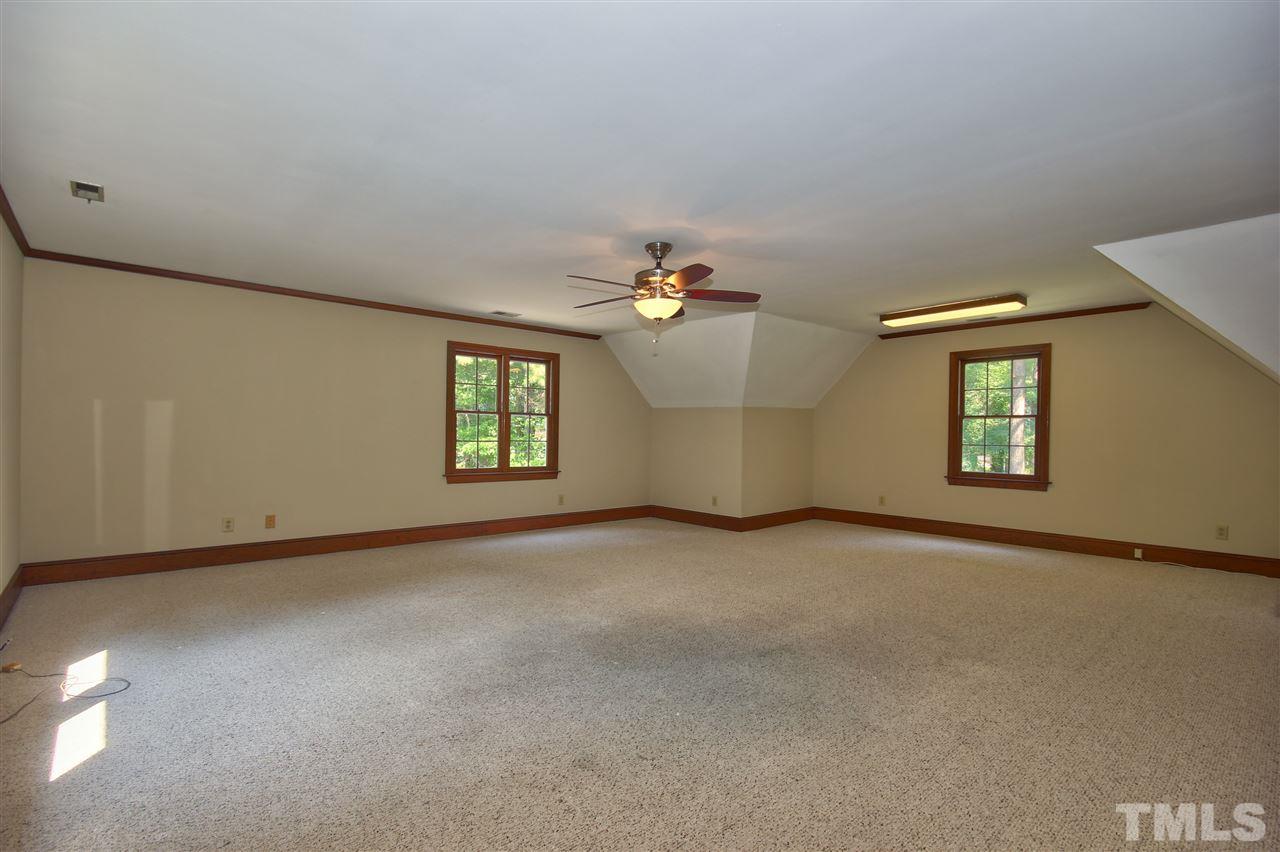 304 Key Court Raleigh, NC 27614 - Photo 17 of 25 an empty room with windows and chandelier fan