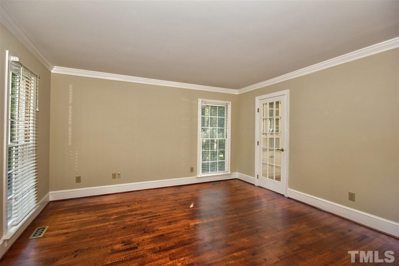 304 Key Court Raleigh, NC 27614 - Photo 4 of 25 an empty room with wooden floor and windows