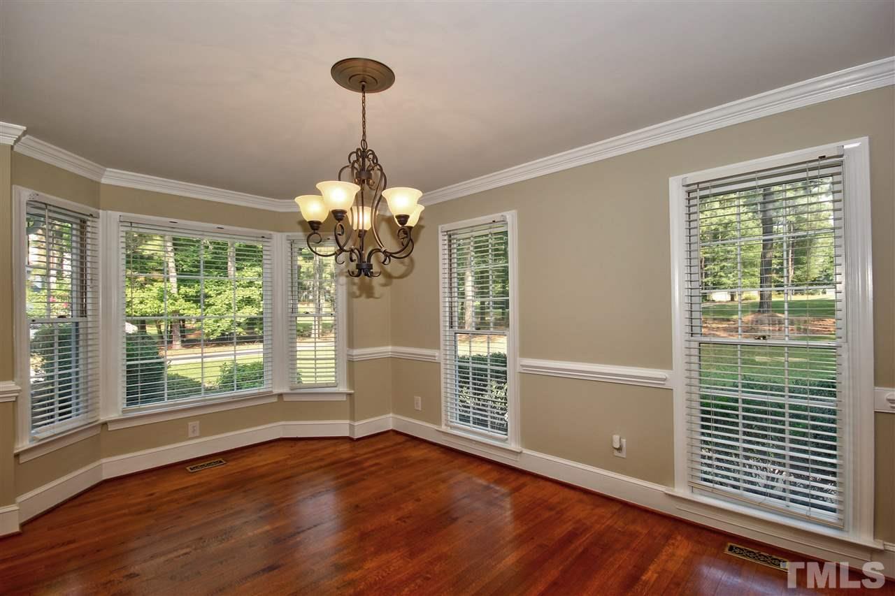304 Key Court Raleigh, NC 27614 - Photo 5 of 25 a view of an empty room with wooden floor and a window