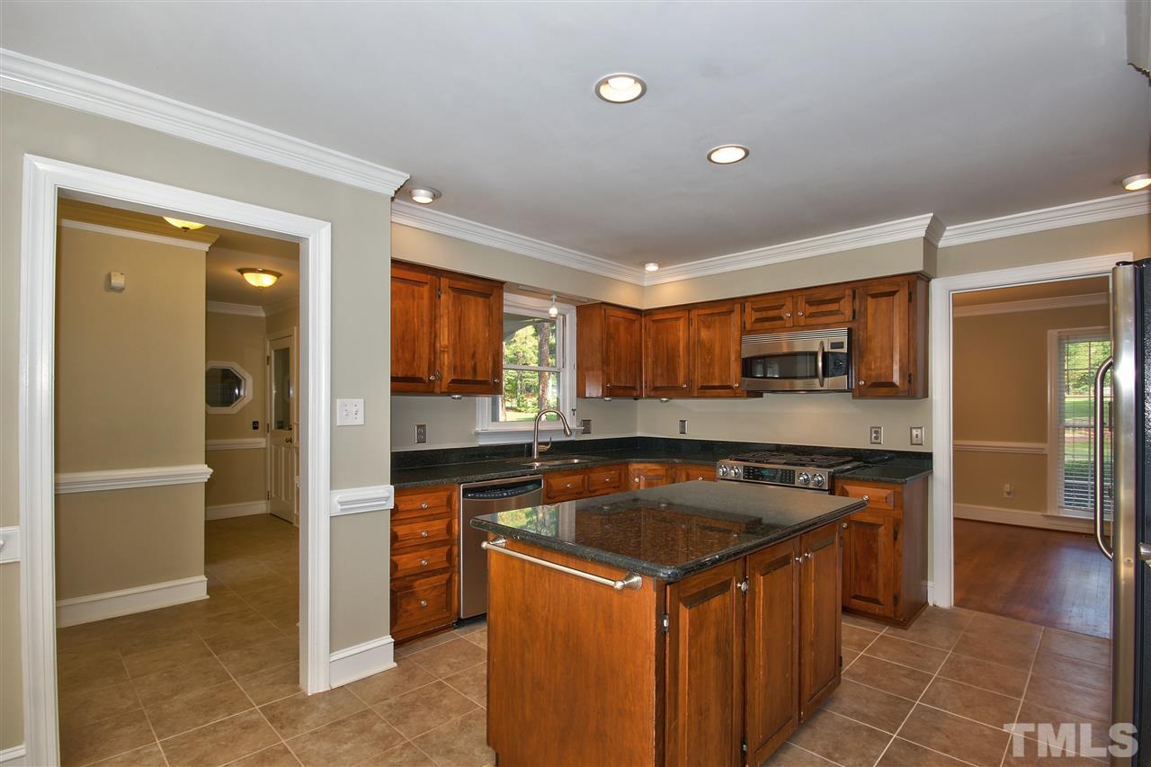 304 Key Court Raleigh, NC 27614 - Photo 7 of 25 a kitchen with stainless steel appliances granite countertop a stove a sink and a refrigerator