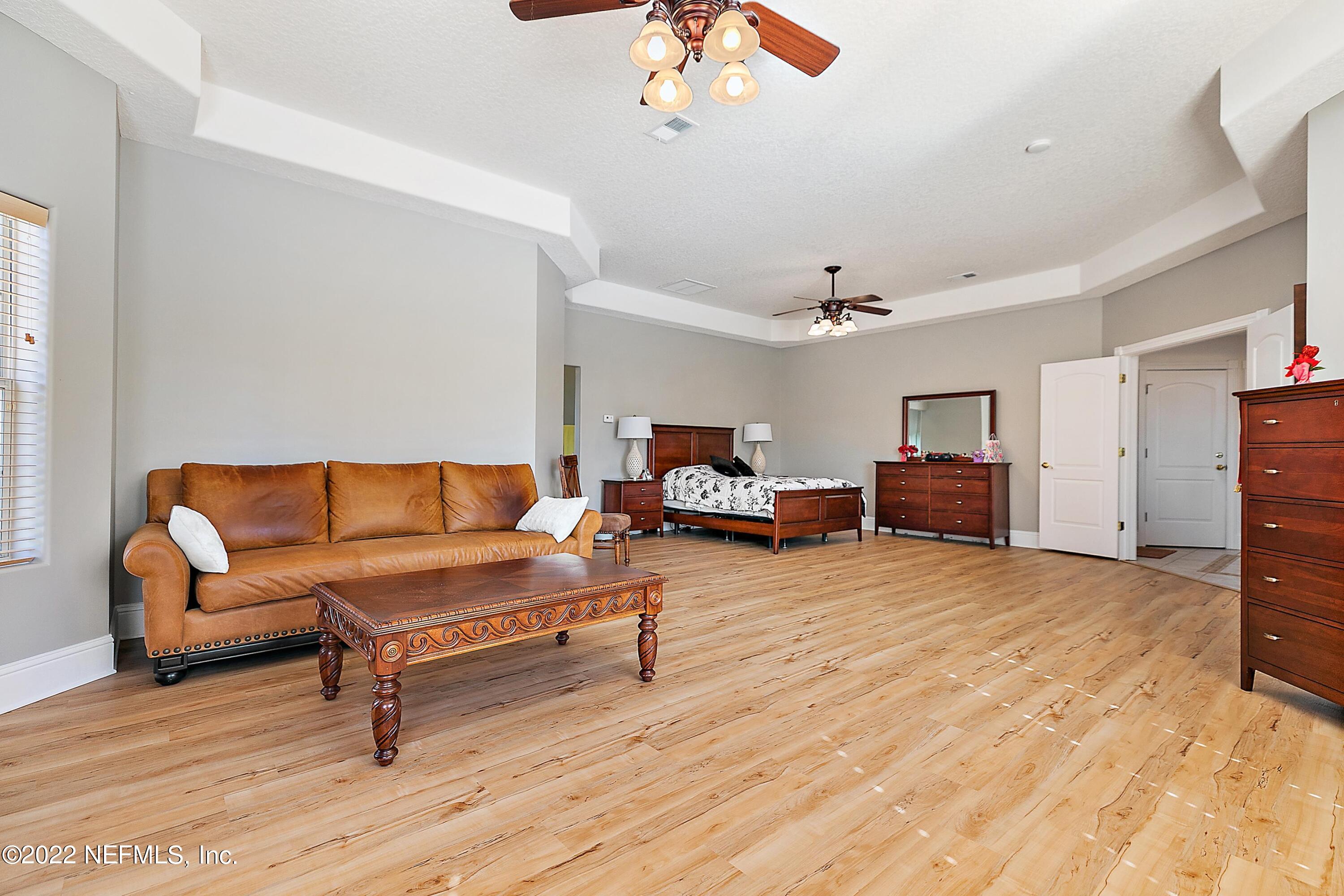 14394 Bob Burnsed Road Glen St. Mary, FL 32040 - Photo 14 of 36 a living room with furniture and a flat screen tv