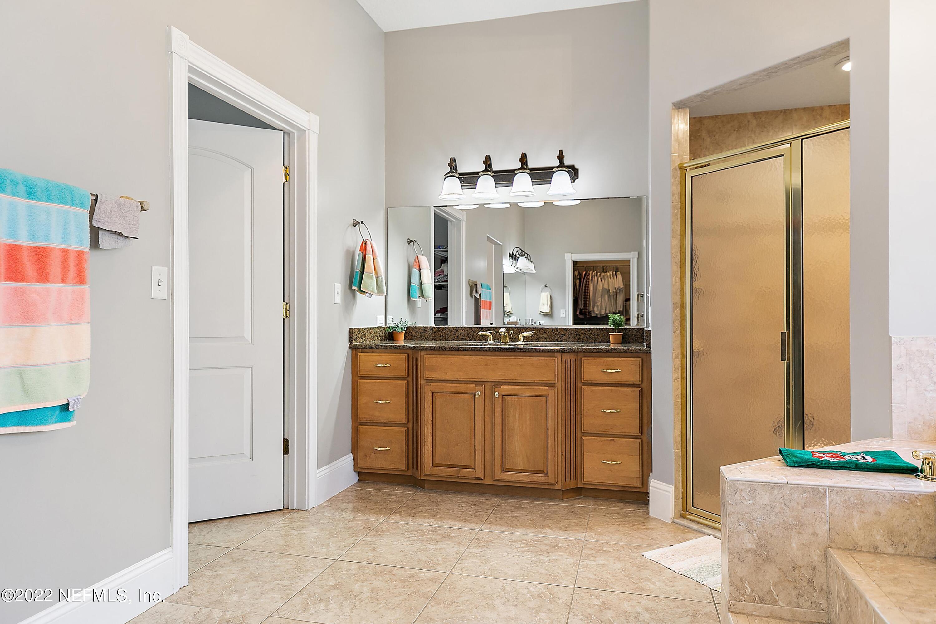 14394 Bob Burnsed Road Glen St. Mary, FL 32040 - Photo 17 of 36 a bathroom with a sink a mirror and a bathtub
