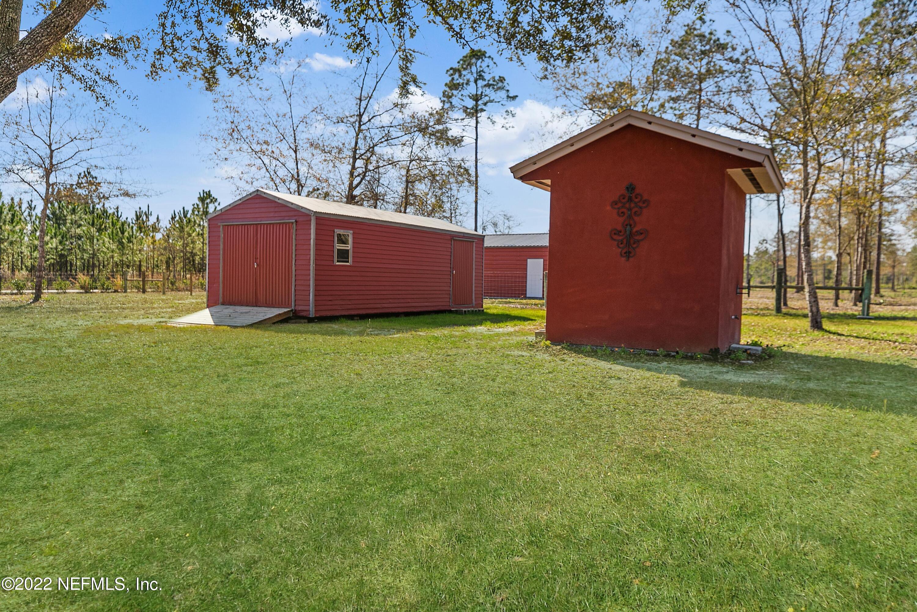 14394 Bob Burnsed Road Glen St. Mary, FL 32040 - Photo 29 of 36 a view of backyard with a barn and large trees