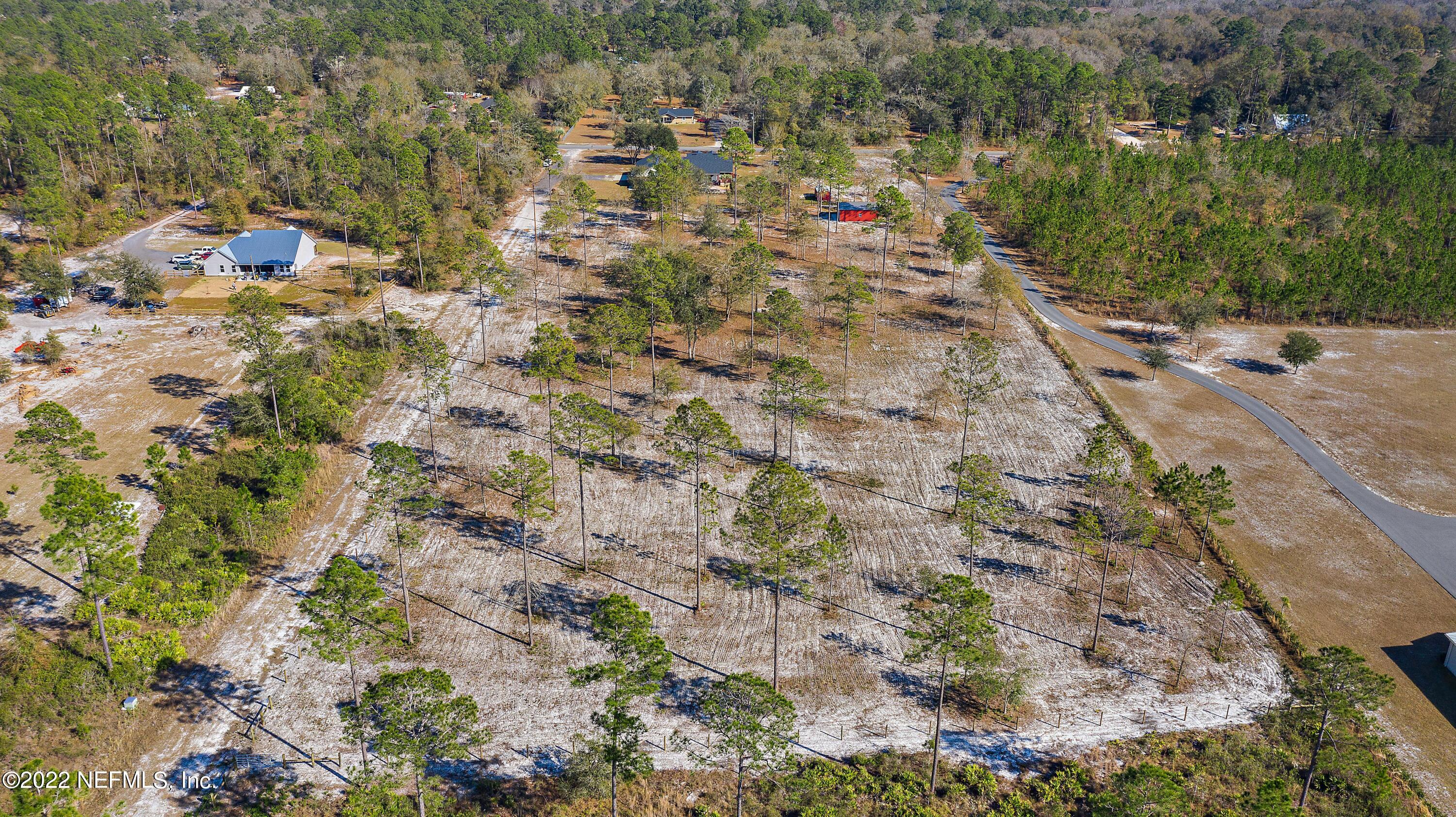 14394 Bob Burnsed Road Glen St. Mary, FL 32040 - Photo 33 of 36 a view of a yard with plants and wooden fence