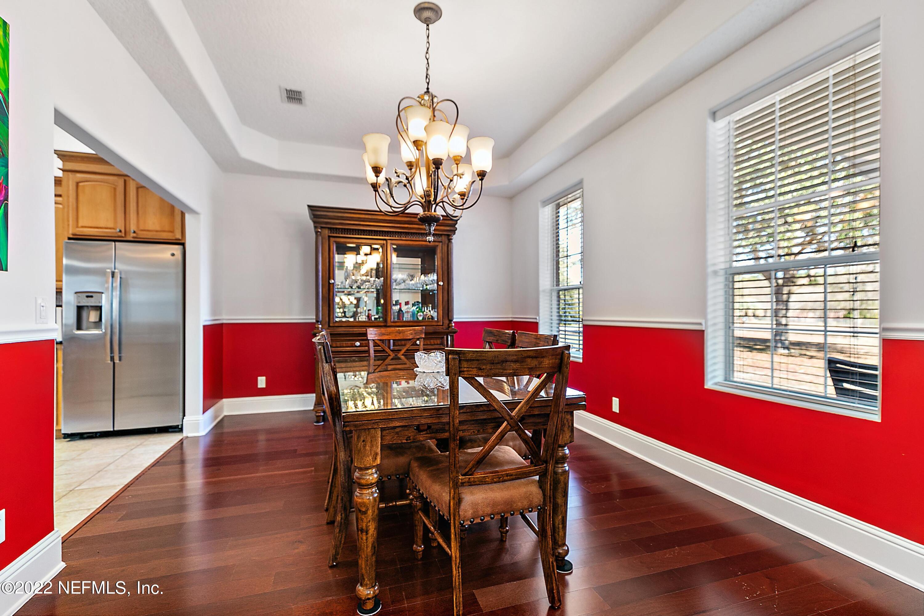 14394 Bob Burnsed Road Glen St. Mary, FL 32040 - Photo 8 of 36 a view of a dining room with furniture a chandelier and wooden floor