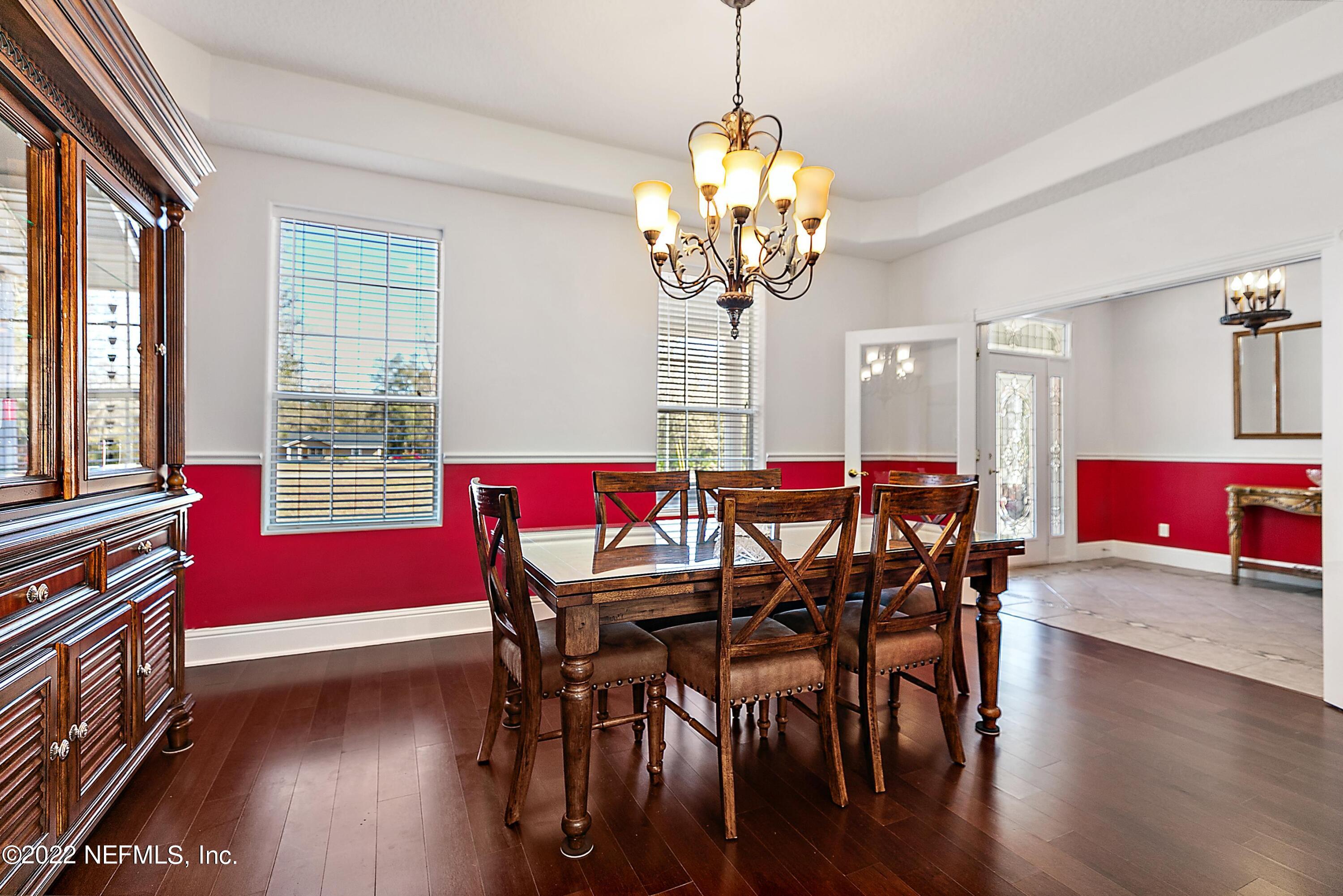 14394 Bob Burnsed Road Glen St. Mary, FL 32040 - Photo 9 of 36 a view of a dining room with furniture wooden floor and chandelier