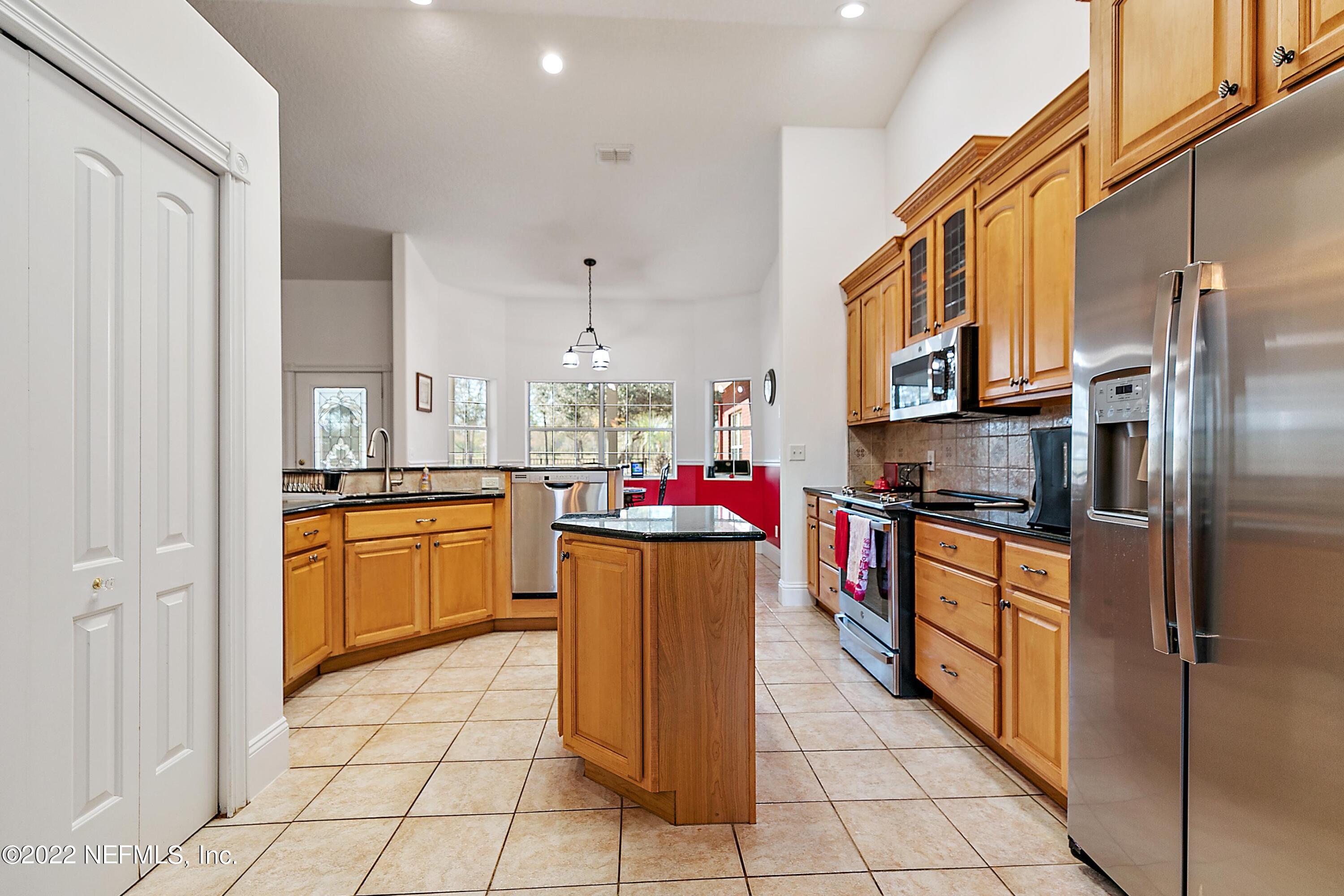14394 Bob Burnsed Road Glen St. Mary, FL 32040 - Photo 10 of 36 a kitchen with stainless steel appliances a refrigerator sink and cabinets