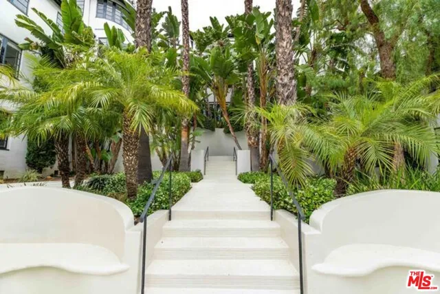 a white house with a tree in the background