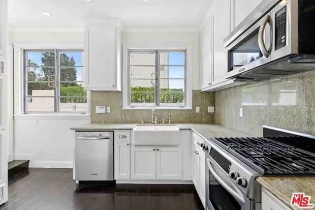 a kitchen with a sink stove and cabinets
