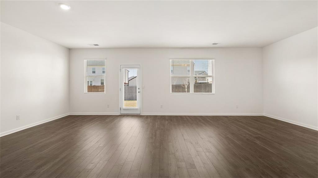 644 Whitman Lane Stockbridge, GA 30281 - Photo 20 of 43 a view of an empty room with wooden floor and a window