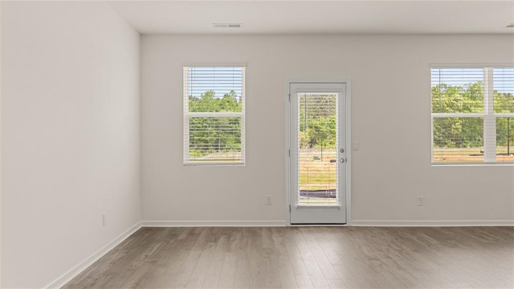 644 Whitman Lane Stockbridge, GA 30281 - Photo 22 of 43 a view of an empty room with wooden floor and a window