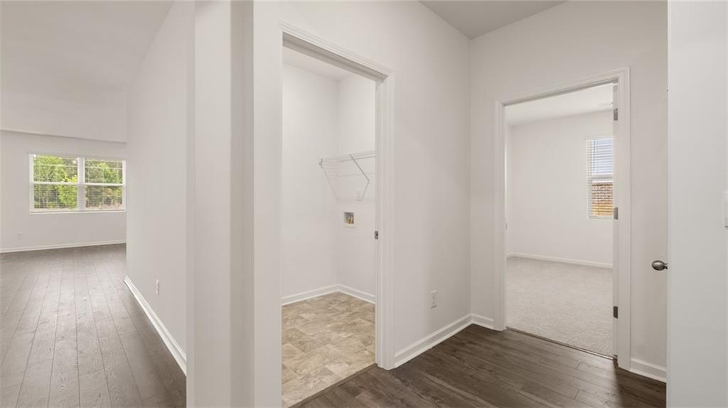 644 Whitman Lane Stockbridge, GA 30281 - Photo 10 of 43 an empty room with wooden floor and windows