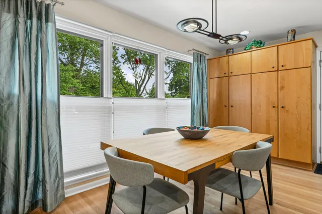 a view of a dining room with furniture window and wooden floor