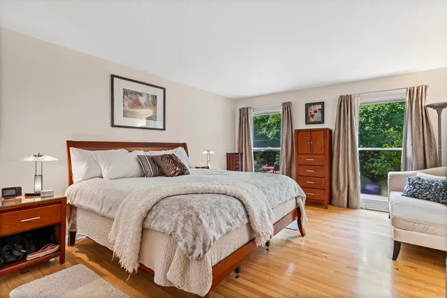 a spacious bedroom with a bed a couch and a window