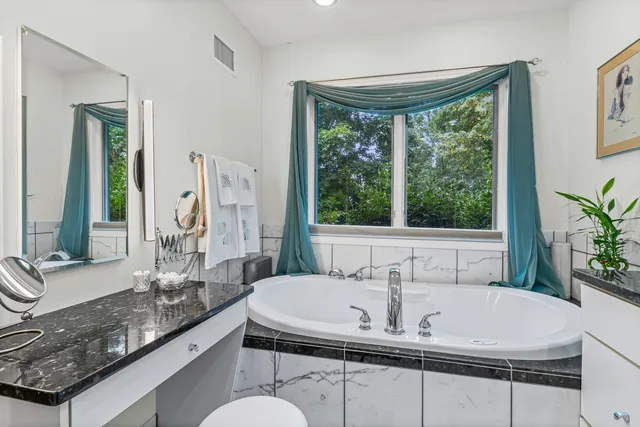 a bath tub sitting next to a window